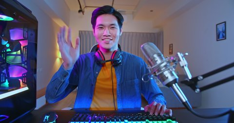 Young Asian Pro Gamer have live stream and say hi to fans happily at home