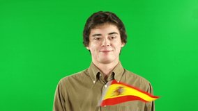 Young Man waving Spain hand Flag in front of Green Screen, Chroma Key Background - Spanish Stock Video Clip Footage