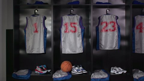 Basketball Changing room / Locker room. All the kit or uniform is laid out ready for the players. Tracking Shot Towards. Stock Video Clip Footage