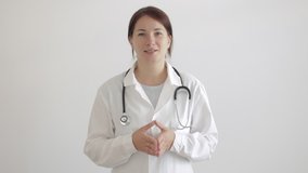 Young woman doctor wear uniform with stethoscope using camera or webcam for consultations patients. Video conference or helping patient online