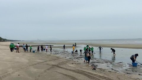 Chonburi, Thailand - May 2020: Group of volunteers collecting garbage. Beach environment pollution.