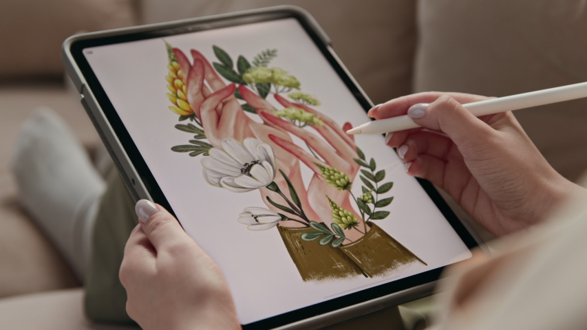 Art of young woman drawing ecological image of flowers in hands at display of digital notepad. Artist sketching colour painting by stylus at tablet computer closeup. Girl in comfort of home interior Royalty-Free Stock Footage #1053097700