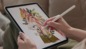 Art of young woman drawing ecological image of flowers in hands at display of digital notepad. Artist sketching colour painting by stylus at tablet computer closeup. Girl in comfort of home interior - Powered by Shutterstock - Get 15% off with code: PIKWIZARD15
