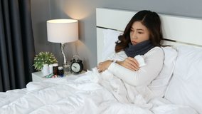 sick woman feeling cold and sneezing in a bed, 4k Video