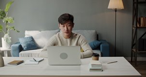 Young asian male college student having an online lesson, talking into laptop. Remote working successful manager has video conference with employees - online education, remote work concept 4k footage