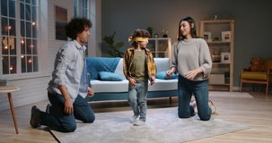 Asian parents playing active games with their child with curly hair at home. Cute blindfold boy catching his parents and laughing - happy family, recreational pursuit concept 4k footage