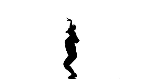 black silhouette on a white background, young beautiful girl dancer in tracksuit and baseball cap dancing hiphop, contemporary, modern street dance, slow motion