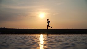 Footage B Roll of Man running and jogging training at beach sunset. Silhouette of male runner working out exercising alone. - Powered by Shutterstock - Get 15% off with code: PIKWIZARD15