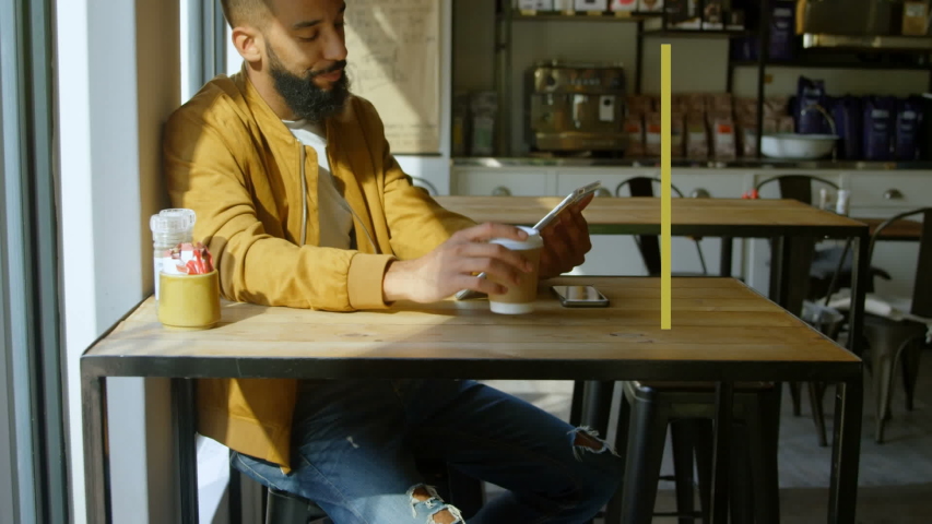 Animation of words Social Distancing appearing on a Caucasian man sitting at table and using a tablet in an empty cafe. Social distancing self isolation in quarantine lockdown.