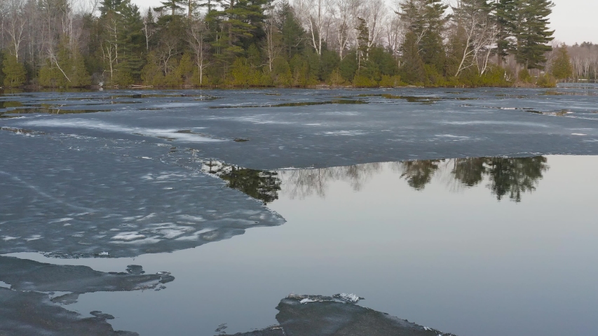 Hebron Lake in Monson Maine melting ice reflective water