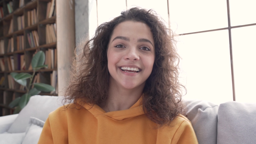 Happy pretty hispanic latin gen z teen girl smiling face waving hand talking to webcam make video call at home talking chatting by virtual video call zoom app online videocall meeting. Webcamera view Royalty-Free Stock Footage #1053123152