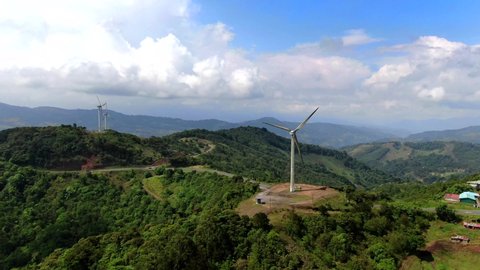 Beautiful cinematic aerial view of the eolian renewable energy wind mild towers in Costa Rica