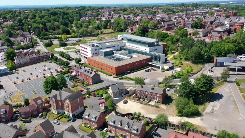 Aerial footage of the Pontefract Hospital located in the village of Pontefract in Wakefield, West Yorkshire in the UK on a sunny summers day showing the Hospital and grounds in the village