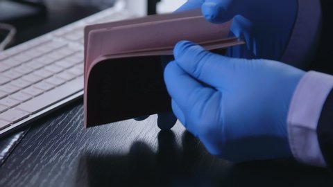 Custom officer checking and stamping a travelling passport. Screening of passengers, travellers for Chinese Covid-19 coronavirus symptoms in International airports