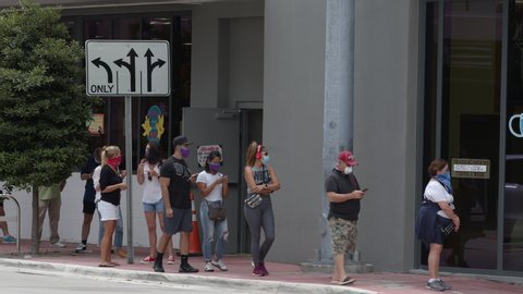MIAMI BEACH, FL, USA - MAY 20, 2020: Miami Beach Coronavirus Covid 19 pandemic people waiting in line Trader Joes 6k blackmagic braw