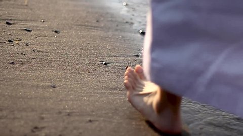 Jesus walking towards the horizon, in the sea, detail shot