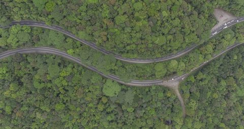 Aerial hyperlapse bird�s eye view of roads in the middle of the forest. Imigrantes road with cars moving different directions. Sao Paulo, Brazil