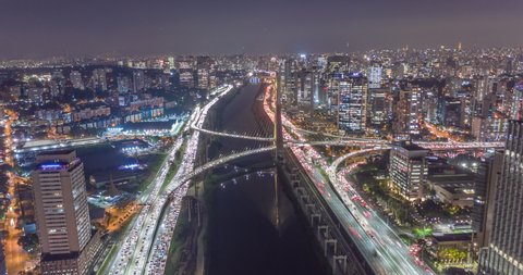 Aerial hyperlapse of Sao Paulo city at night with cars, trains and helicopters. Heavy traffic, buildings and city lights. Brazil