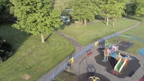 Empty public park playground aerial view above quarantine corona covid virus lake trees area