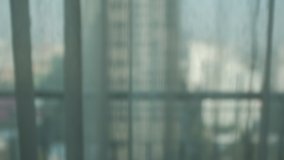 sheer curtain (translucent fabric) and balcony with city view from high rise building, lonely feeling after staying home all day or all week, living alone in self-isolation, shallow depth of field - Powered by Shutterstock - Get 15% off with code: PIKWIZARD15