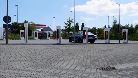 Pfalzfeld, Rhineland-Palatinate / Germany - 05.22.2020: Tesla car on Tesla Supercharger near highway A61 in Germany. 