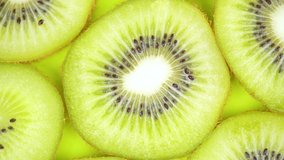 Timelapse footage of ripe slices of kiwi fruit spinning on the table. Shot in 4k resolution