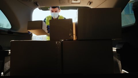 Man loads boxes of medicines in the trunk of the car