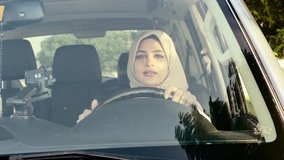 Beautiful woman wearing traditional clothes from united arab emirates. Young lady driving her car in Dubai
