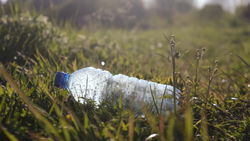 The guy picks up a plastic bottle close up. Trash-free planet concept. Nature cleaning, volunteer ecology green concept. Environment plastic pollution. Care about nature. Royalty-Free Stock Footage #1053163082
