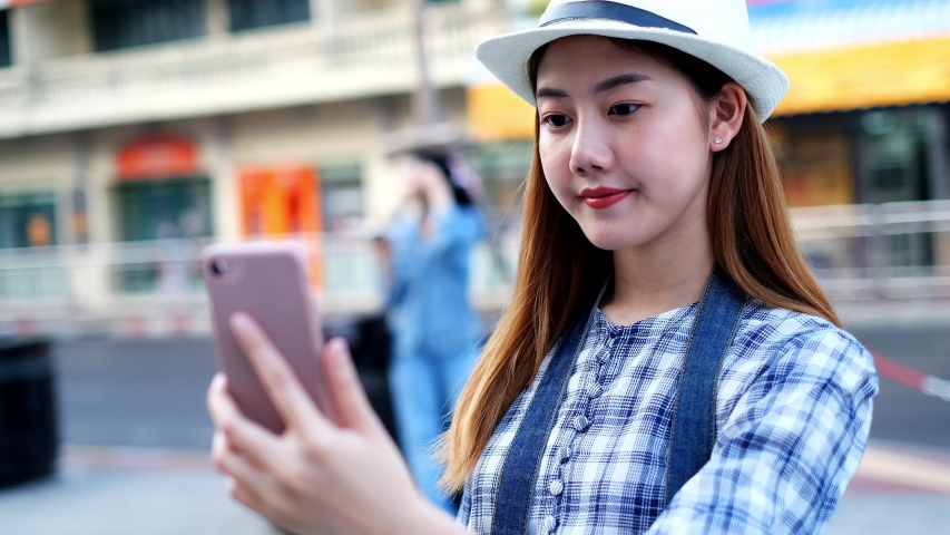 Traveler Asian blogger women travel in Bangkok, Thailand, beautiful female using mobile phone make vlog and live in social media .woman tourist making video call with smartphone while traveling. | Shutterstock HD Video #1053164723