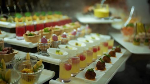 Close-up shoot of the buffet counter full of fruits and sweets. A stylish dessert buffet with vapors.