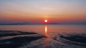 Aerial view footage of sunrise featuring Penang Bridge in Penang Island, Malaysia.
