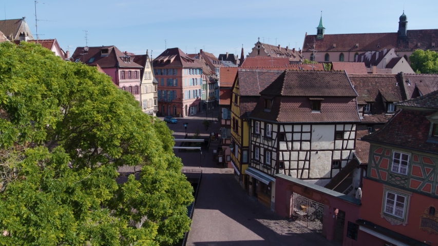 Aerial drone shot of the city of Colmar in Alsace France. Quiet street during summer with blue sky. | Shutterstock HD Video #1053174803