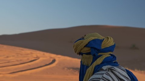 Merzouga / Morocco - 12 19 2018: Merzouga Sahara Desert Morocco - December 19, 2018: Berber man in Moroccan national clothes. Young Tuareg man in Merzouga, Morocco.