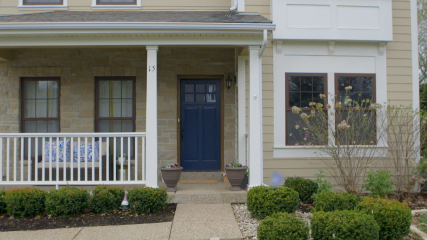 Girl alone at home walks out of house and looks up and down the street