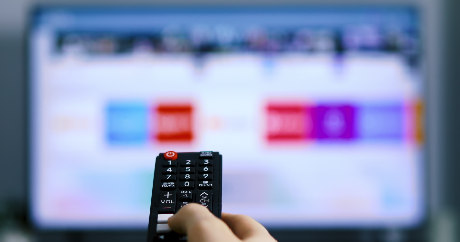 Accessing apps on smart TV with remote control. Searching among different apps on smart television. 4k | Shutterstock HD Video #1053181070