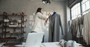 Asian female clothing designer is drawing her sketches on graphics tablet, preparing her new collection - fashion, success concept 4k footage