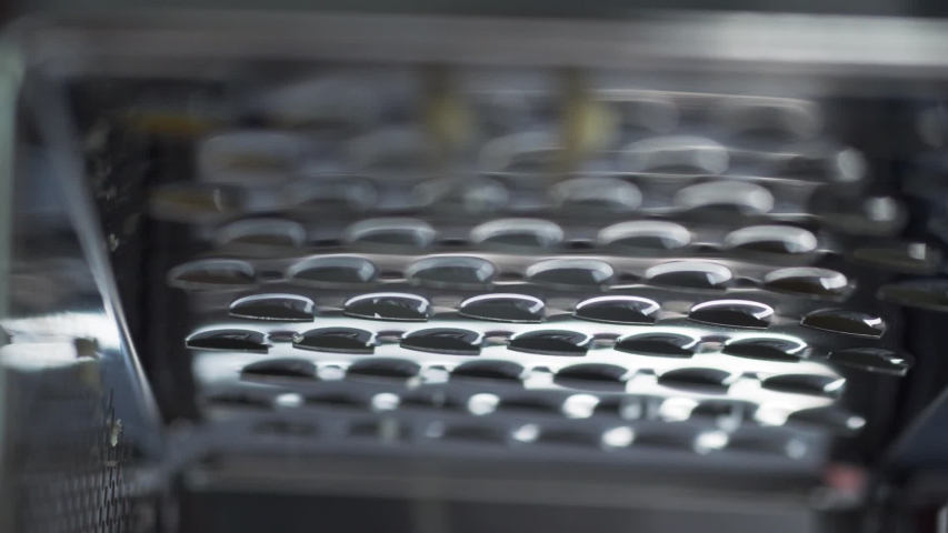 Inside view of a grater through which cheese is rubbed and with small chips will fall down Royalty-Free Stock Footage #1053189980