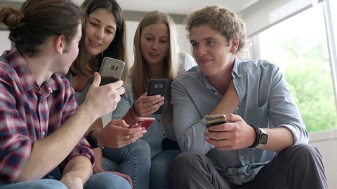 group of four young people with their phone