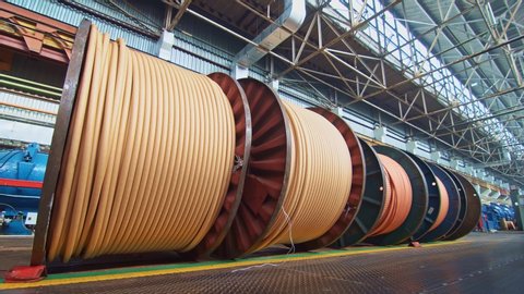 Cable factory. Metal, optical, copper, power wires are wound on huge coils. Products are used in the energy, transport, construction, engineering, nuclear, defense, oil and gas industries.