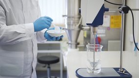 man scientist testing chemical mixing stirrer. Spbd add powder to rotating water. pharmaceutical lab. concept biotechnology, experiment, tool. development of new drugs - Powered by Shutterstock - Get 15% off with code: PIKWIZARD15
