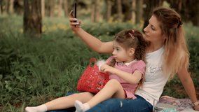 Happy Family Mom With Kid Daughter Use Mobile Phone Selfie App.Cute Children Having Fun Touching On Cellphone Screen.Little Small Child With Mother Make Video Call In Internet Social Network.