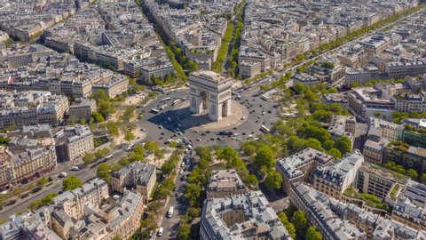 sunny day flight over paris city famous triumph arch traffic circle aerial timelapse panorama 4k france