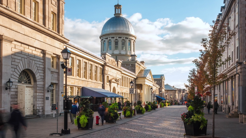Montreal, Quebec, Canada, zoom out timelapse view of Old Montreal historic neighbourhood including architectural landmark Bonsecours Market on a sunny day.