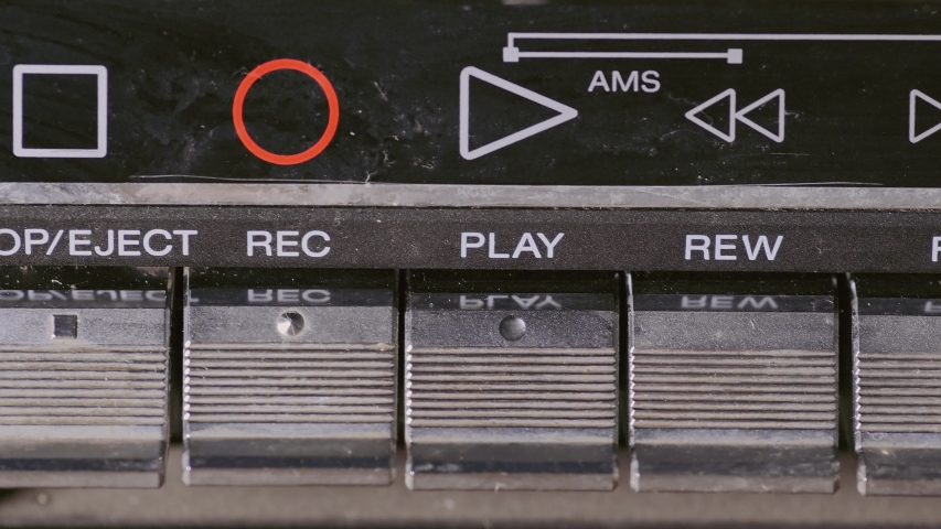 Man finger pressing some buttons on an old retro vintage cassette tape player: play, rewind, fast forward, stop | Shutterstock HD Video #1053215408