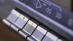 Man finger pressing some buttons on an old retro vintage cassette tape player: play, rewind, fast forward, stop - Powered by Shutterstock - Get 15% off with code: PIKWIZARD15