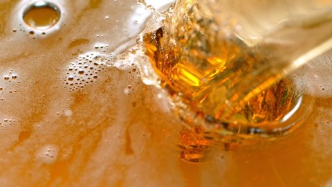 Super Slow Motion Detail Shot of Pouring Beer into Glass at 1000fps.