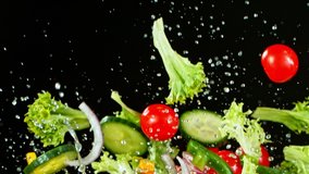Super Slow Motion Shot of Flying Fresh Vegetables and Water Splash on Black Background at 1000fps. - Powered by Shutterstock - Get 15% off with code: PIKWIZARD15