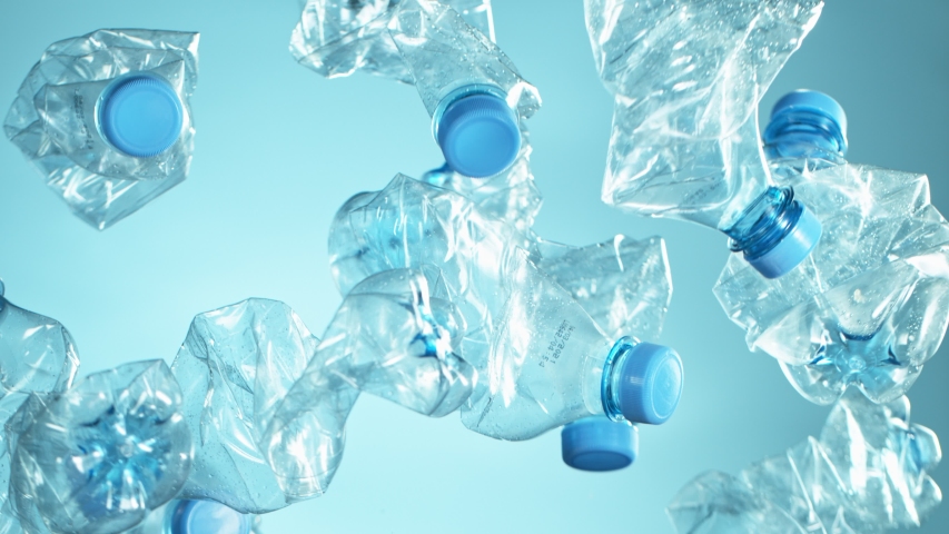Super Slow Motion Shot of Flying Empty Plastic Bottles on Light Blue Gradient Background at 1000fps. | Shutterstock HD Video #1053217994