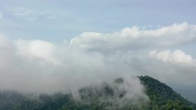 Hyperlapse video of clouds over mountain forest	